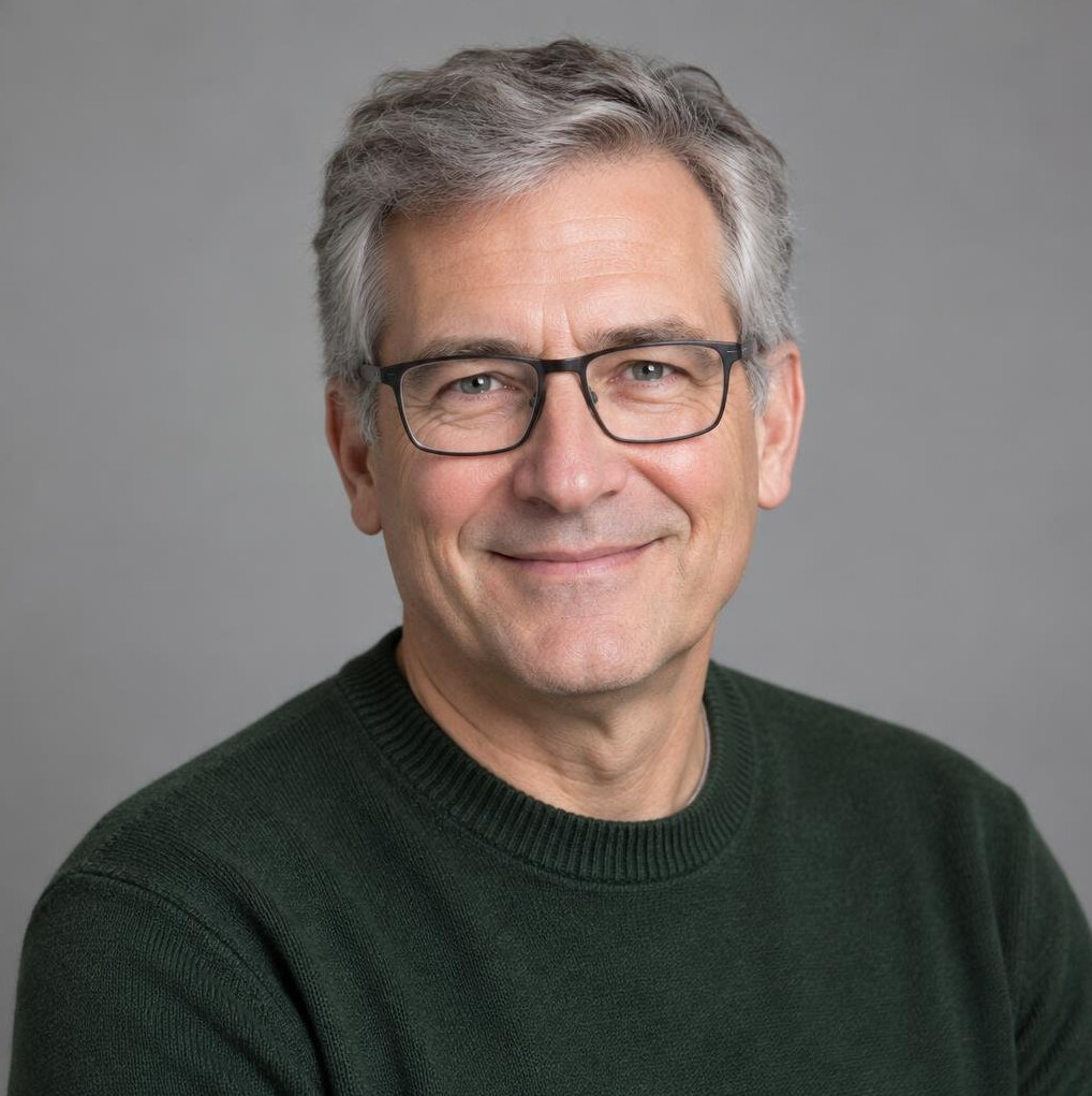 Portrait of a mature man with grey hair and glasses smiling